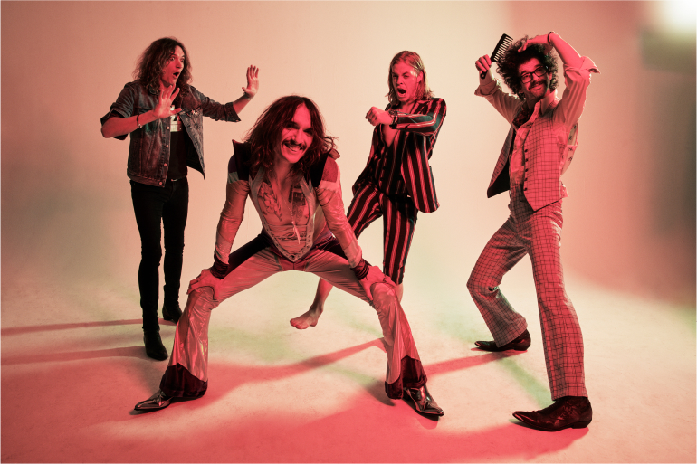 The Darkness band photo with red lighting